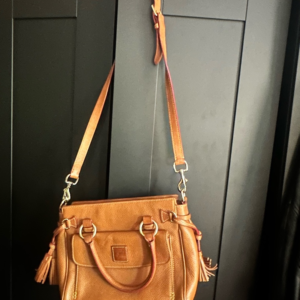 Dooney and Burke classic pebbled leather purse with tassels.